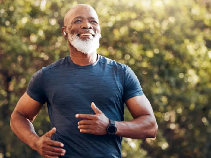 Smiling mature man jogging outdoors